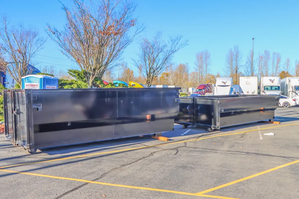 Professional dumpster rental service with roll-off container on residential driveway in Zeeland